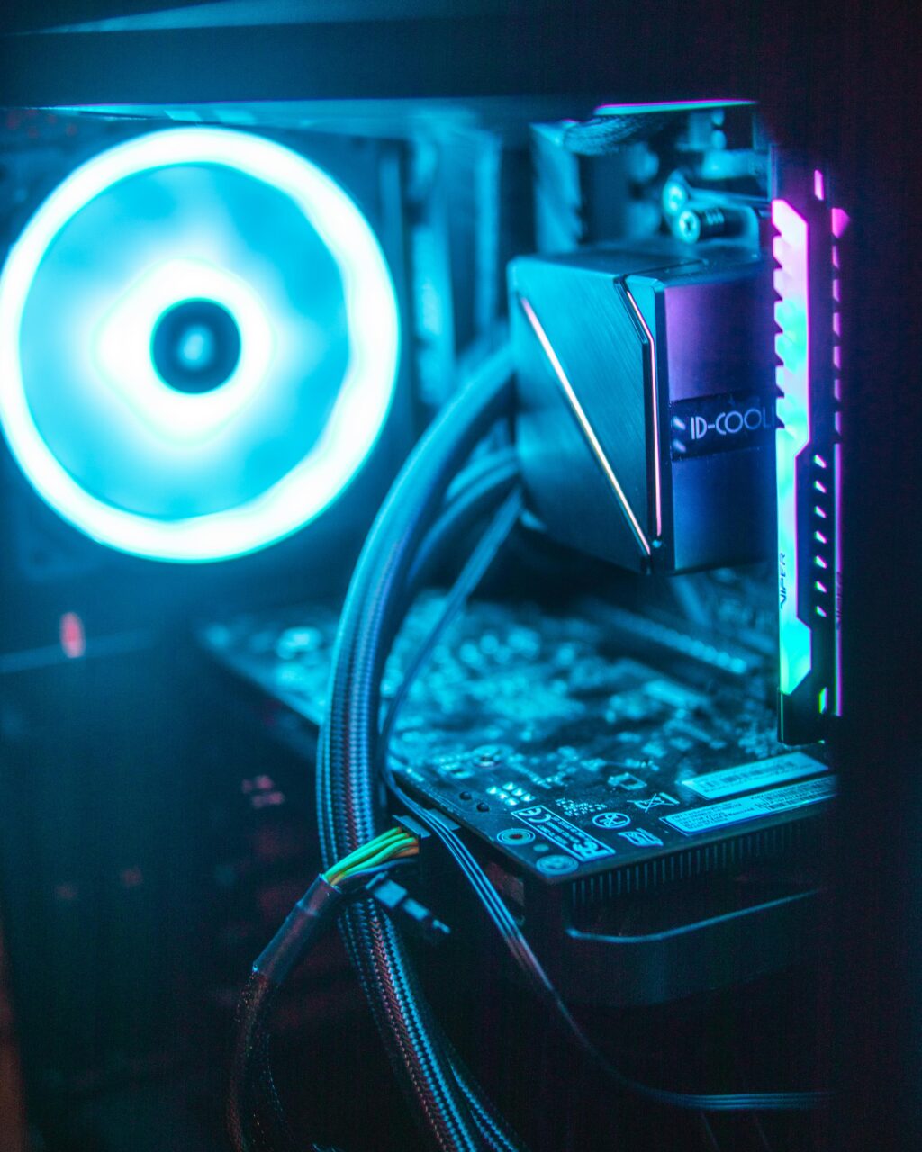 Vibrant RGB lighting on modern computer hardware components inside a desktop.