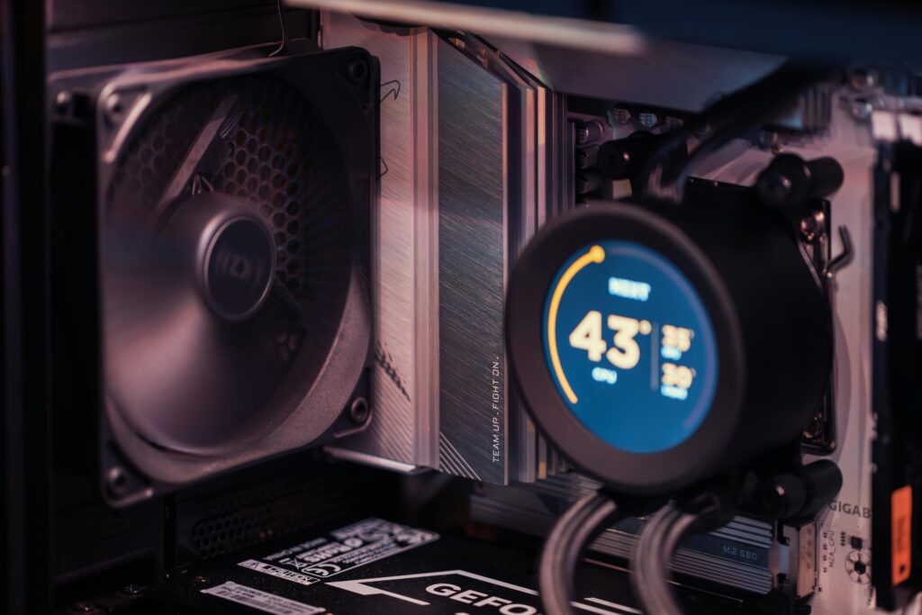 pexels-photo-34552810-34552810 Close-up of a gaming PC build showcasing GPU, fan, and liquid cooling system.
