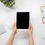 Aerial view of a minimalist home office setup with tablet and accessories.