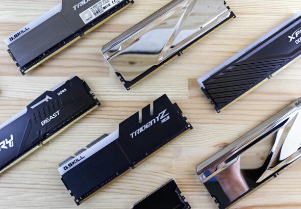 Top view of modern computer RAM sticks arranged on a wooden surface for technology enthusiasts.