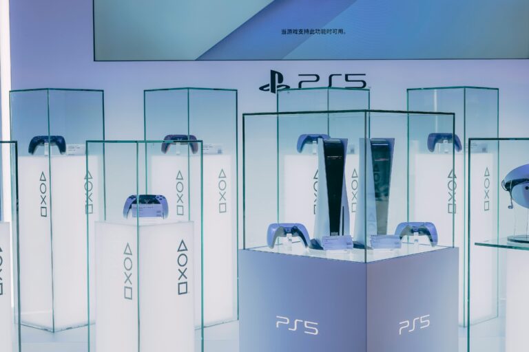 PlayStation 5 consoles and accessories on display in a sleek, futuristic showroom.