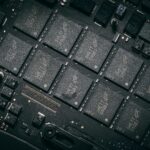Detailed view of electronic circuit board components showcasing microchips and technology intricacies.