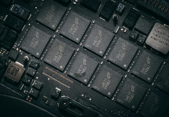 Detailed view of electronic circuit board components showcasing microchips and technology intricacies.