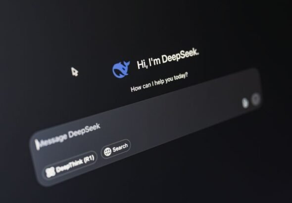 Close-up of a laptop displaying an AI interface with a chatbot prompt in dark mode.